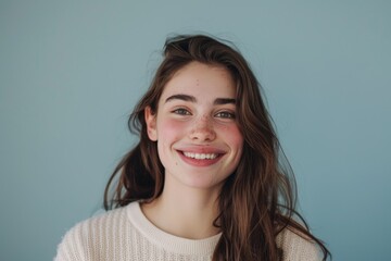 Fototapeta premium Portrait of a young woman smiling happily in stand position.