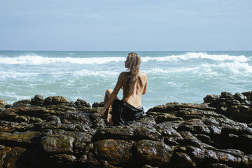 Woman on the rocks of a beach