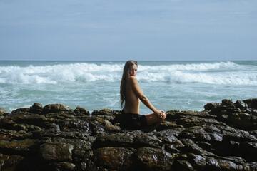 Woman on the rocks of a beach
