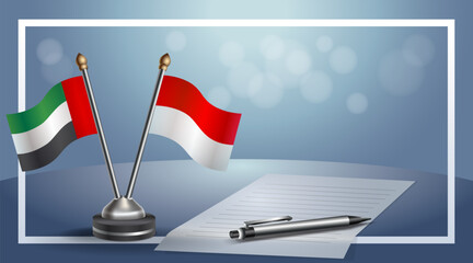 United Arab Emirate and Indonesia National flags on small table with bokeh background, cooperative relationship