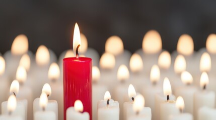 Red Candle Amidst White Candles Creating a Serene and Tranquil Atmosphere