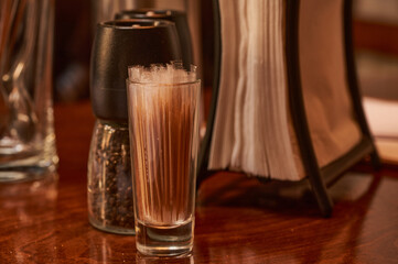 Close-up of a glass with toothpicks on the table. Shallow depth of field.        