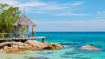 Relaxing moments on Koh Munnork Island with stunning turquoise waters and rustic pier