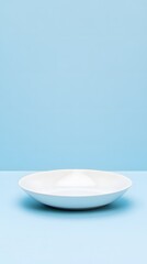 White plate on blue background. Minimal style. Copy space.