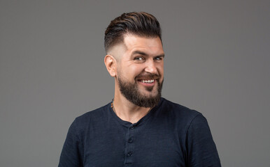 Bearded man, stylish hairstyle. Young bearded man, stylish hairstyle, beard. Perfect beard. Portrait of stylish man. Smiling male portrait isolated