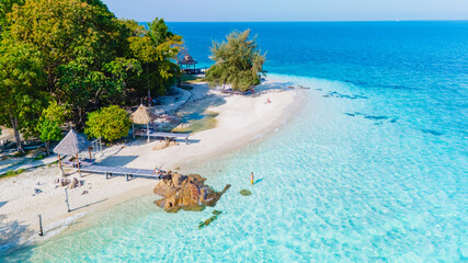 Relaxing beach day at Koh Munnork Island in Rayong, Thailand with pristine waters and lush greenery