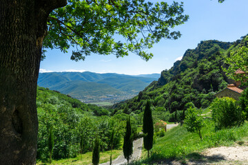 View from Shio-Mgvime monastery to the Mtkvari (Kura) river valley, village, mountains. Bright blue sky in the background © Michael