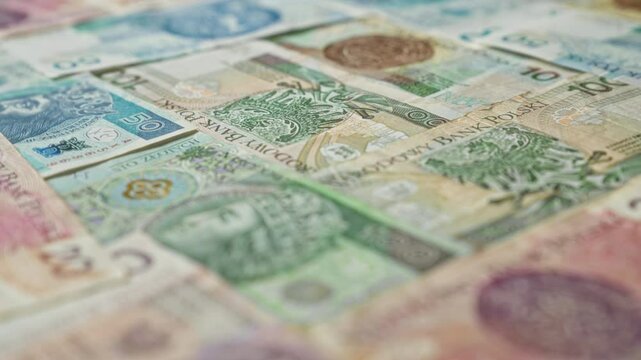 Polish banknotes showcasing various denominations including 50, 100, and 200 zloty notes, highlighting the currency of poland in a detailed close-up view.