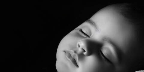 A peaceful black and white portrait of a baby sleeping soundly, capturing innocence and tranquility, evoking feelings of love, care, and sentimentality.