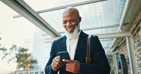 Phone, walking and businessman in city with communication for corporate travel with email. Happy, commuting and African mature CEO with online hotel checkin with cellphone for company trip in town.