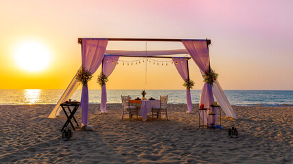 The sunset view scene with romantic dinner set up on the beach