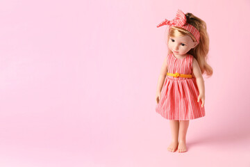 Beautiful doll in dress and headband on pink background. Space for text