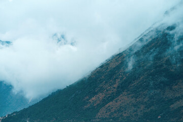 Dense fog creates a moody and atmospheric mountain scene