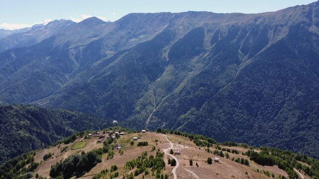 Aerial view of small village on ridge overlooking Caucasus mtn valley
