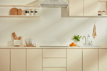 The photograph of contemporary kitchen in beige color tone with modern interior from frontal shot. Blank space for design, product displaying and adding text