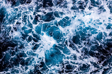 Ocean water background. Top view of vibrant foamy water. Can be used in covers, packaging, posters, textures, brochures, art, and design projects. Captivating nature background image.
