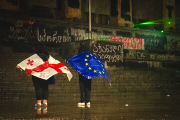 Tbilisi, Georgia - 1st december, 2024: Protesters georgians by parliament protest and stand for EU. European Union manifestation. Protests against Government.Security spray water on demonstrators