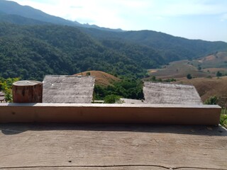 Wood table bar, Top table perspective, empty wide wooden table top with blurred beautiful mountain forest scene background in summer daytime. Resort clean wood desk board on nature view in nature.