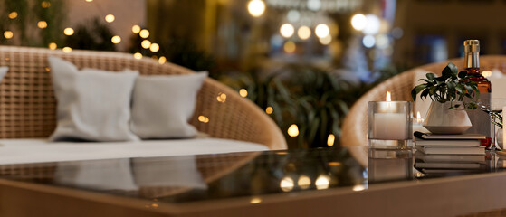 A coffee table in a beautiful living room at night featuring glowing lights create a warm atmosphere