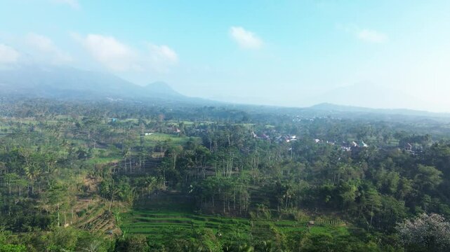 4k footage of rural atmosphere in the morning with views of mountains and rice fields and clear skies