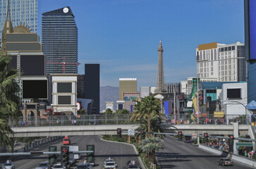 Neon signs, glitz casino hotel resorts, traffic and highrise city skyline in superlative gambling...