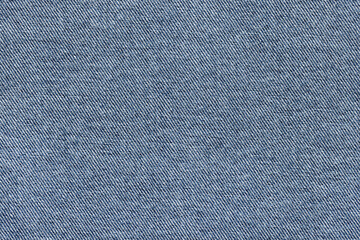 Denim fabric, classic color, for jackets, jeans and other clothes, close-up. Background, texture.