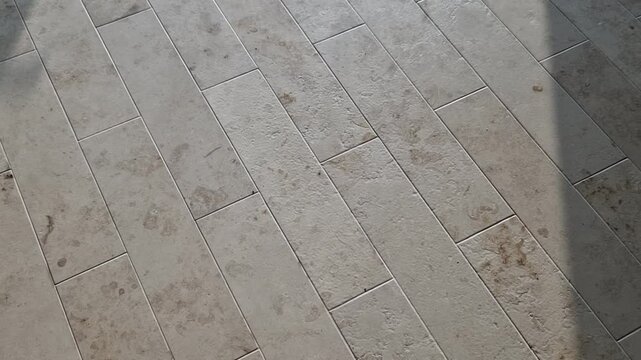 light floor of elongated tiles in stripes. Mediterranean style in the lobby of a luxury building