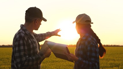 farmers cooperation. farmers wheat in field work discussion collaboration. farm with tablet and...