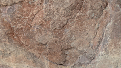 Texture of natural stone block as background. Part of granite textured in color 2025 Mocha Mousse.