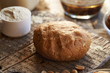 Dough made of whey protein powder, maple syrup and peanut butter - preparation of homemade protein chocolate bars