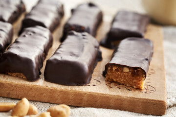 Healthy homemade choocolate bars made of whey protein powder, peanut butter and dates