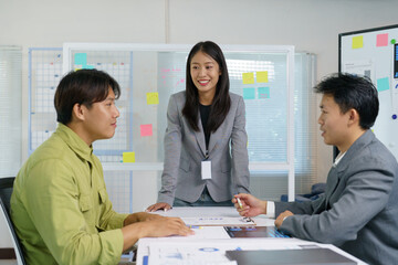 The operations manager organizes a meeting presentation to the office staff team. Colleagues using a whiteboard with a presentation Analyze growth, charts, statistics and business data in office.