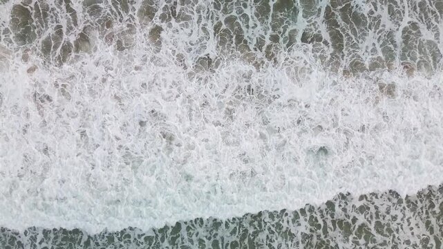 4k footage of foamy waves crashing, with angels from above