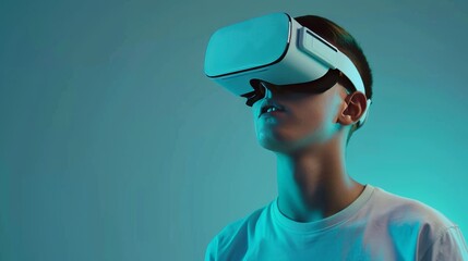 A young man wearing opaque virtual reality goggles, tilting his head in curiosity