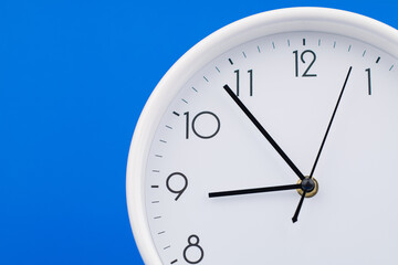 Fototapeta premium Clock telling time and working on time photo in studio on blue background