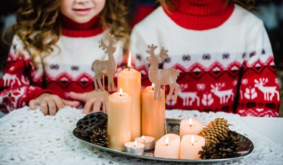 Chrismtas time, candles and cone on the table
