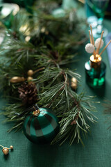 Christmas decorations festive composition on the green linen cloth. Close up