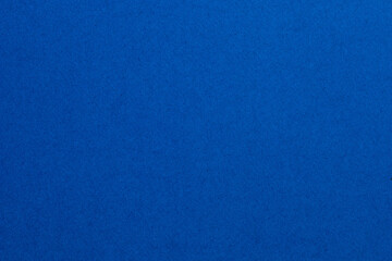 A blue background with a few small dots, textured origami paper backdrop