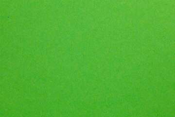 A green field with grass and no visible objects, textured origami paper backdrop