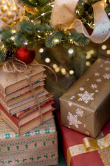 Gifts and books under Christmas tree. Boxing Day. vertically