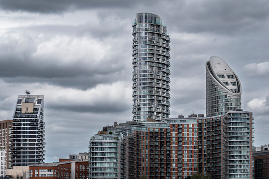 An eye-catching perspective of futuristic tower structures highlighted by a dramatic cloudy sky, symbolizing innovation and modern architectural excellence in urban design in London UK