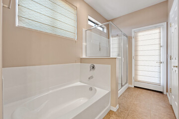 Bright and spacious bathroom with modern amenities and large window for natural light