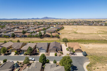 Residential neighborhood with a scenic mountain backdrop and clear skies in the afternoon light