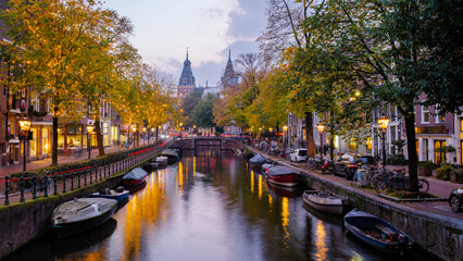 Exploring the enchanting autumn colors along Amsterdam's serene canals at twilight