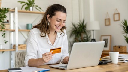 Happy office manager shopping online, browsing web stores, buying annual mobile app membership spending her salary holding orange credit card in hand

