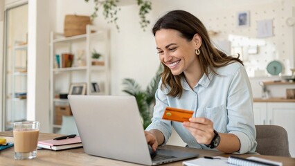 Happy office manager shopping online, browsing web stores, buying annual mobile app membership spending her salary holding orange credit card in hand
