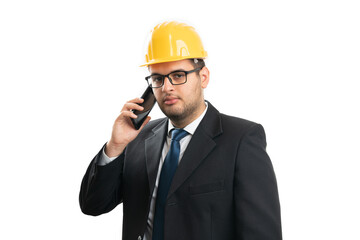 Architect serious expression wearing helmet speaking on phone