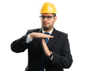 Engineer or architect wearing hardhat showing timeout gesture