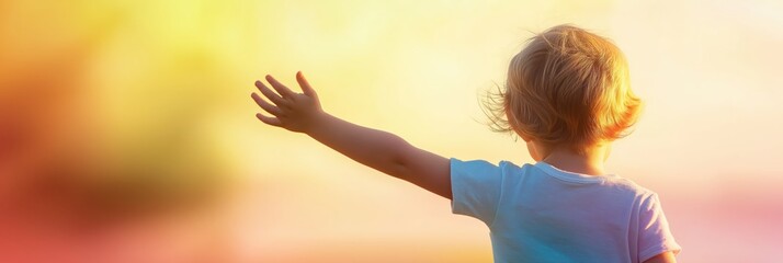 A sweet child waves goodbye in a beautiful sunset atmosphere, embodying the feelings of joy, innocence, and hope during a warm evening outdoors.