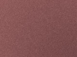 Fototapeta premium Dusty rose textured background with subtle variations in tone.